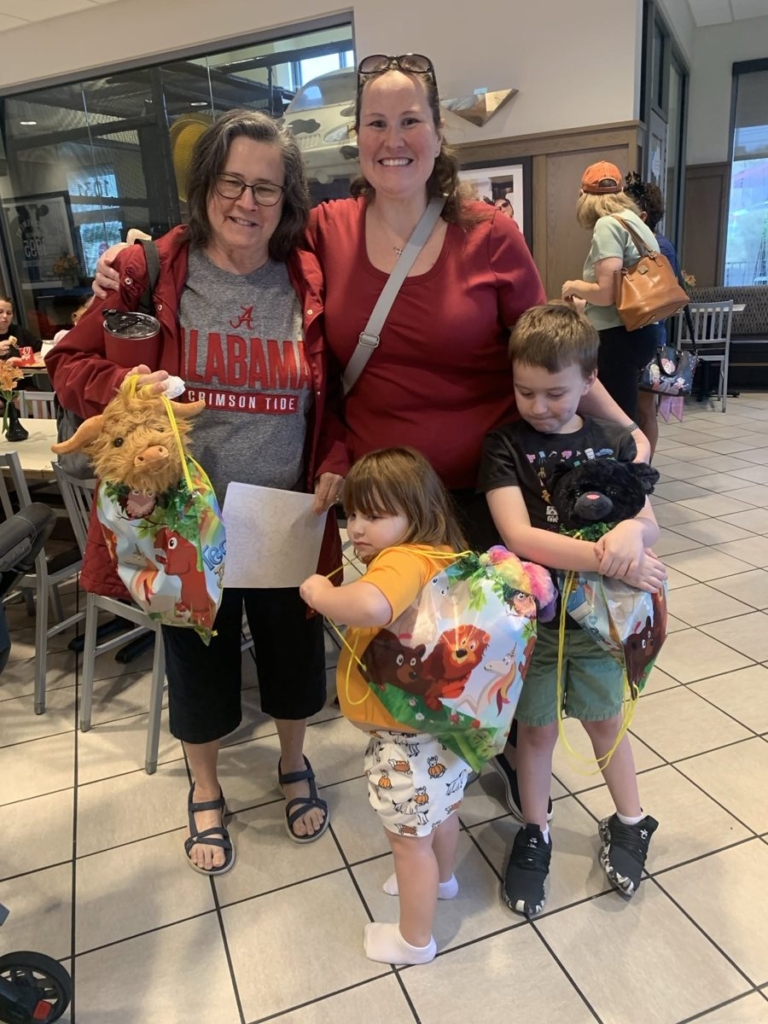 Family showing off their new stuffed animals at Chick-fil-A Georgetown Kids Night